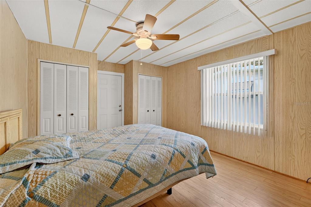 165 Shady Lane Eustis, FL 32726 - Photo 17 of 25 a bedroom with a bed and a chandelier
