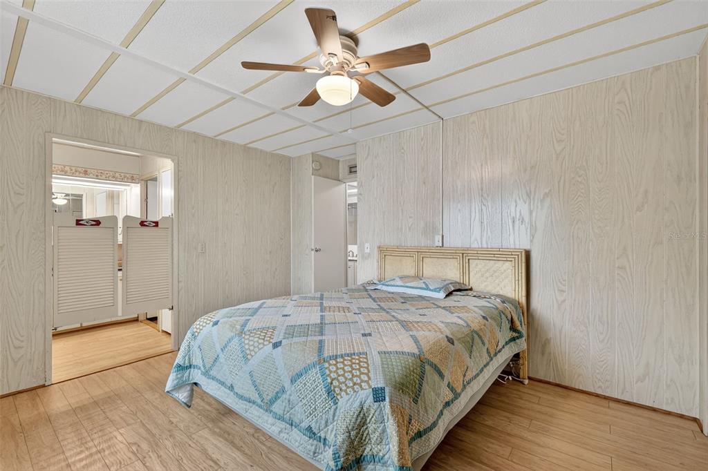 165 Shady Lane Eustis, FL 32726 - Photo 20 of 25 a bedroom with a bed and a ceiling fan