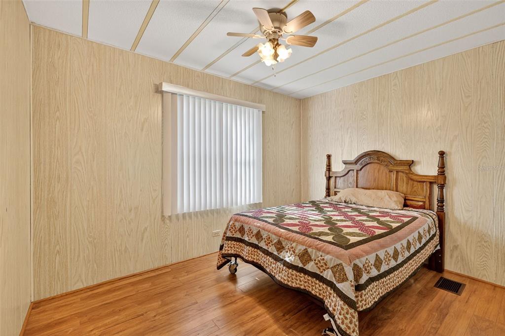 165 Shady Lane Eustis, FL 32726 - Photo 21 of 25 a bedroom with a bed and window