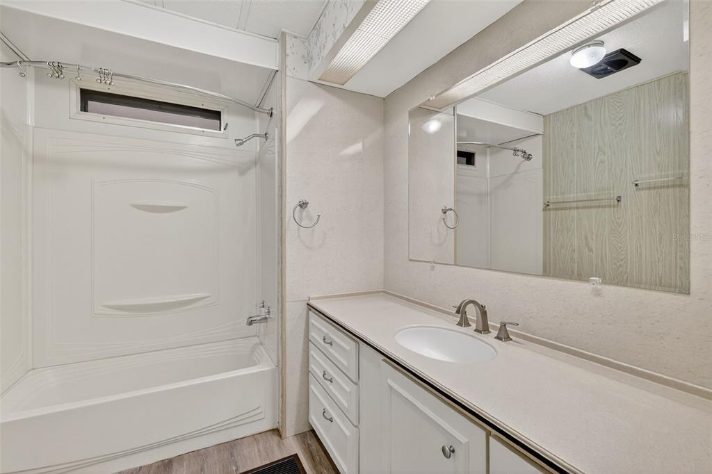 165 Shady Lane Eustis, FL 32726 - Photo 22 of 25 a bathroom with a granite countertop sink toilet and shower