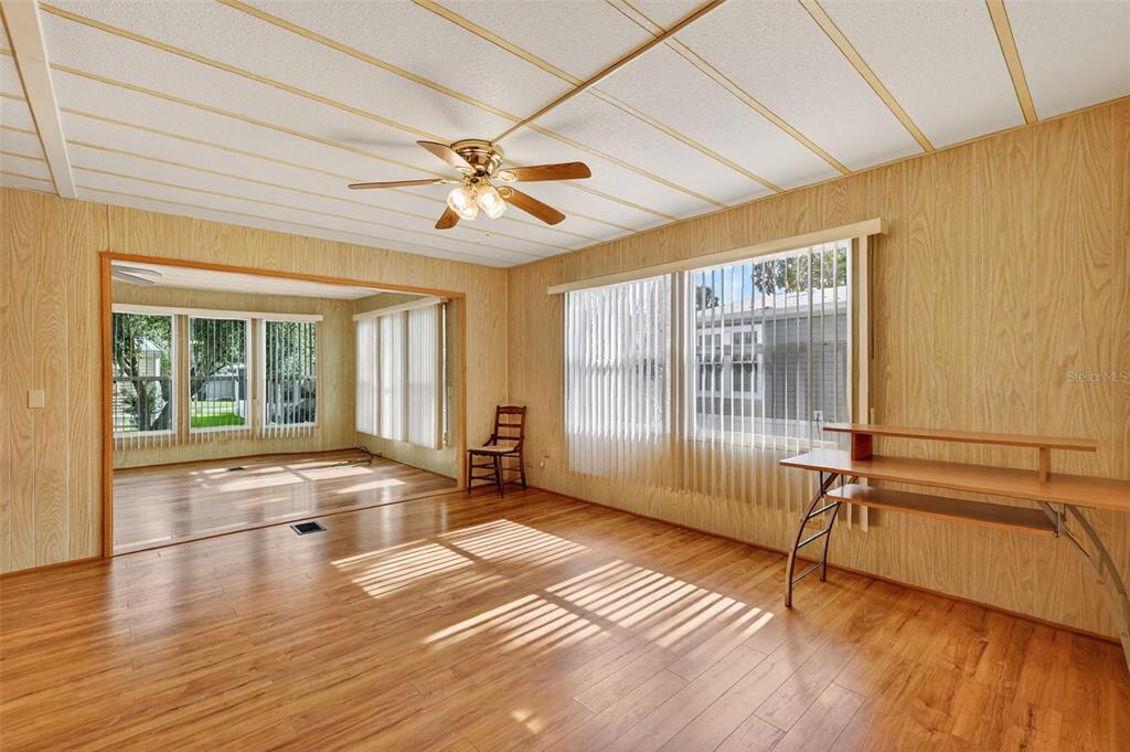 165 Shady Lane Eustis, FL 32726 - Photo 6 of 25 a view of an empty room with a window and wooden floor