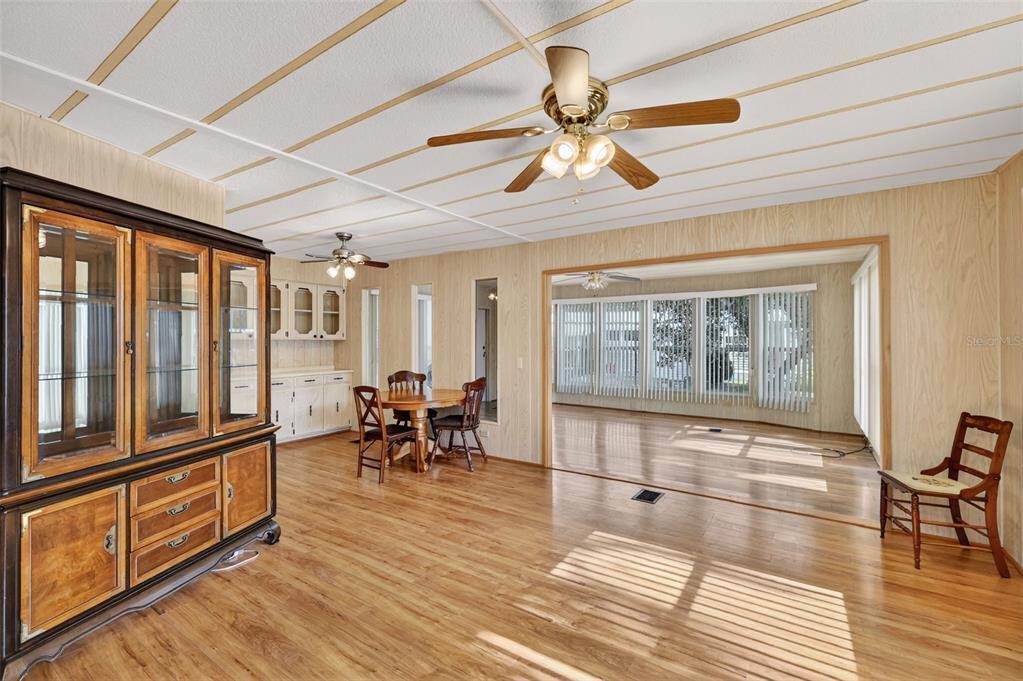 165 Shady Lane Eustis, FL 32726 - Photo 8 of 25 a view of a room with lots of furniture and wooden floor