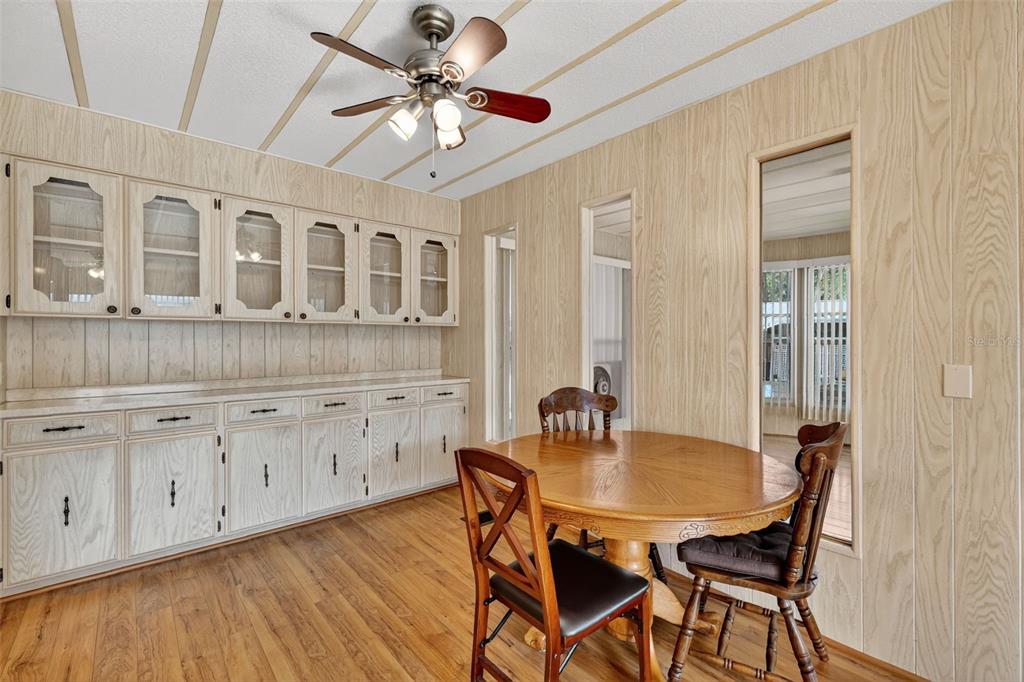 165 Shady Lane Eustis, FL 32726 - Photo 9 of 25 a view of a dining room with furniture window and wooden floor