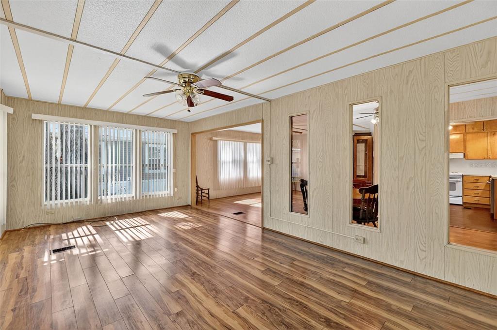 165 Shady Lane Eustis, FL 32726 - Photo 10 of 25 a view of a livingroom with wooden floor and a ceiling fan