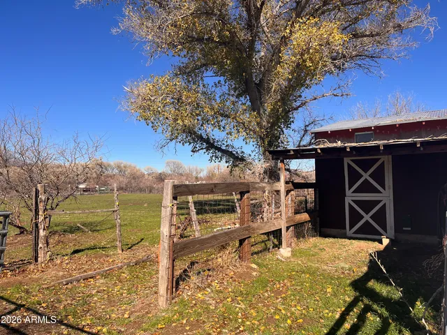 a view of a backyard with wooden fence