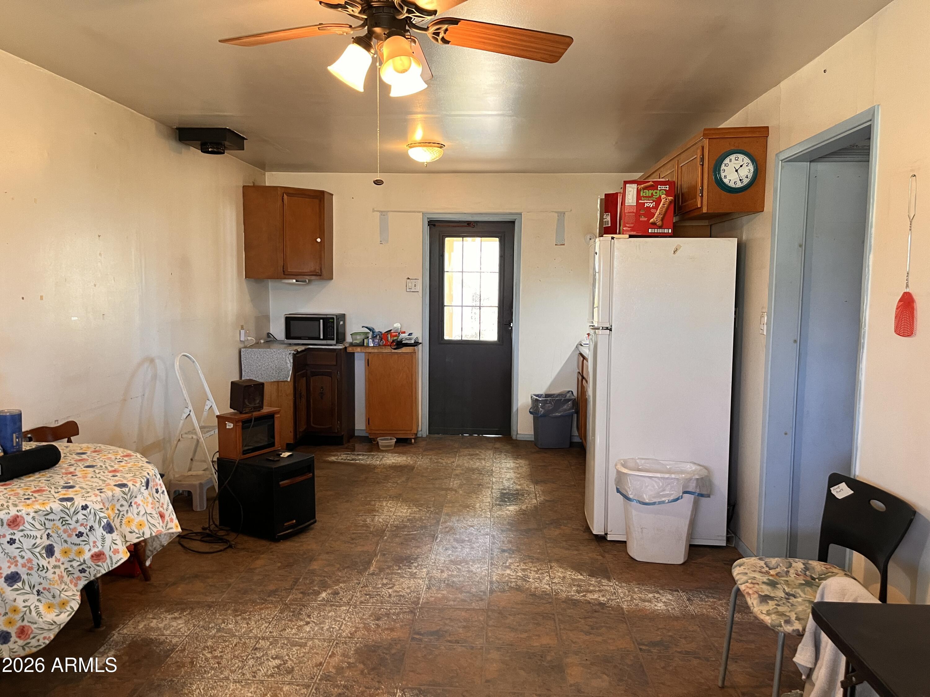 3140 Iron Springs Road Skull Valley, AZ 86338 - Photo 5 of 37 a bedroom with a bed and a chandelier