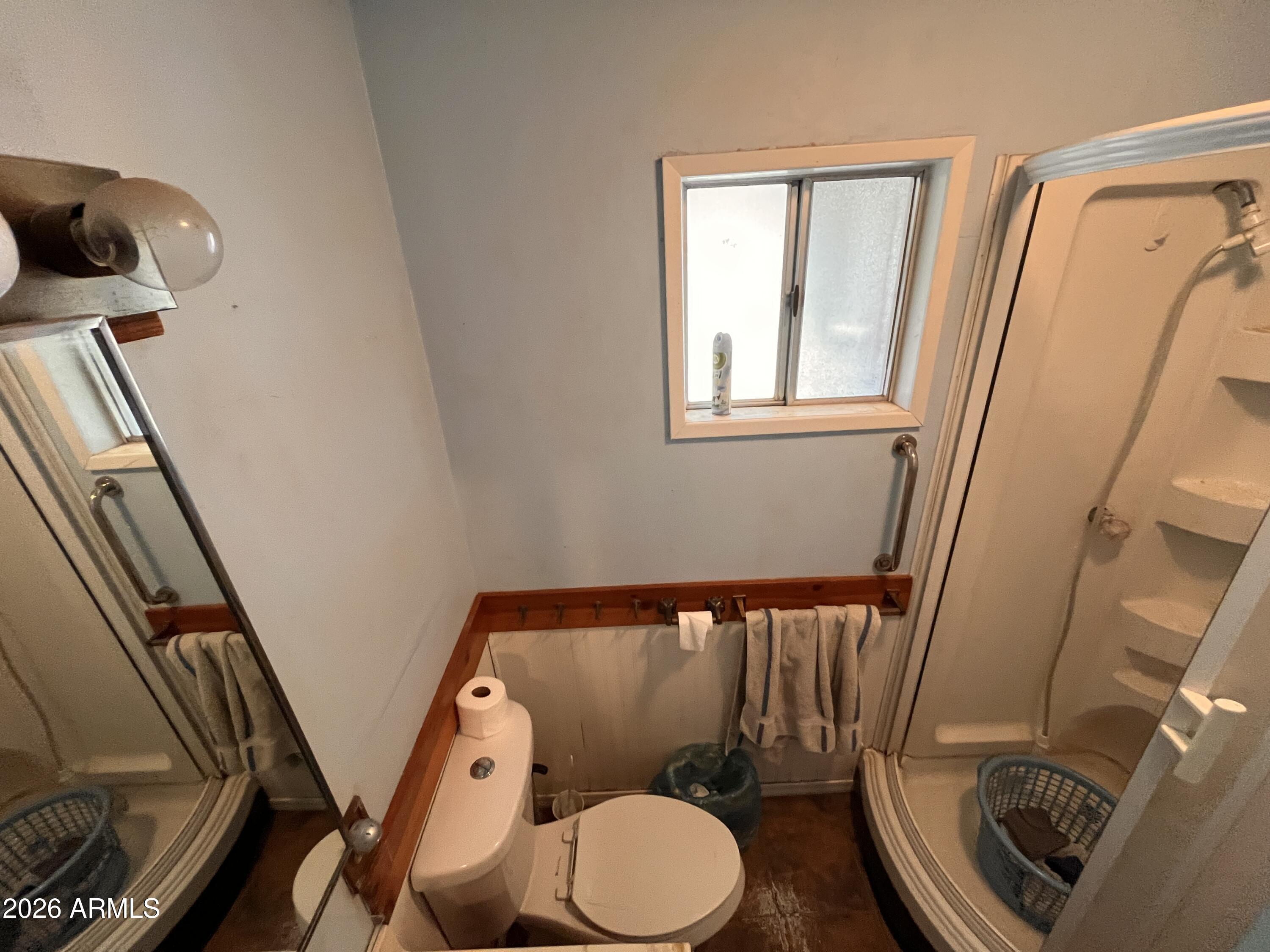 3140 Iron Springs Road Skull Valley, AZ 86338 - Photo 9 of 37 a bathroom with a toilet and a mirror