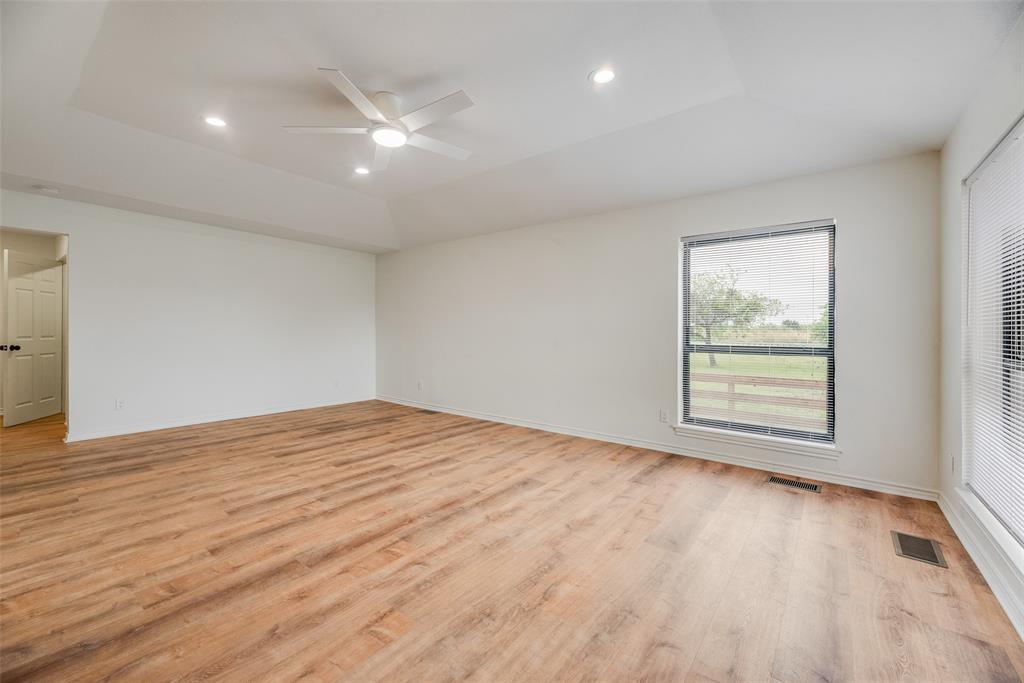 2720 Seeton Road Grand Prairie, TX 75054 - Photo 12 of 31 a view of an empty room with wooden floor and a window