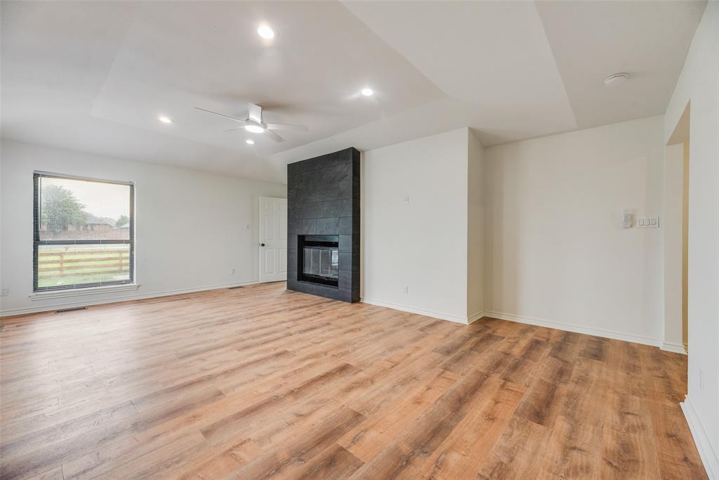 2720 Seeton Road Grand Prairie, TX 75054 - Photo 13 of 31 a view of an empty room with wooden floor and a window