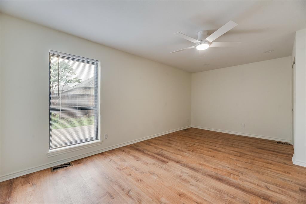 2720 Seeton Road Grand Prairie, TX 75054 - Photo 18 of 31 an empty room with wooden floor and windows