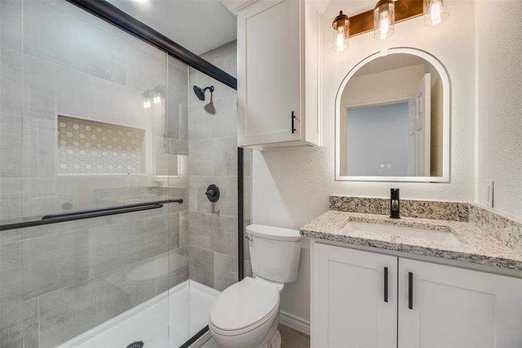 2720 Seeton Road Grand Prairie, TX 75054 - Photo 19 of 31 a bathroom with a granite countertop sink toilet and shower