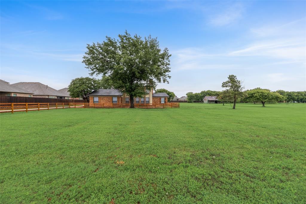 2720 Seeton Road Grand Prairie, TX 75054 - Photo 25 of 31 a view of a green field with house in the background
