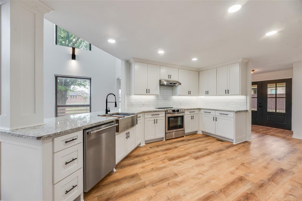 2720 Seeton Road Grand Prairie, TX 75054 - Photo 6 of 31 a large kitchen with stainless steel appliances lots of counter space and wooden floor