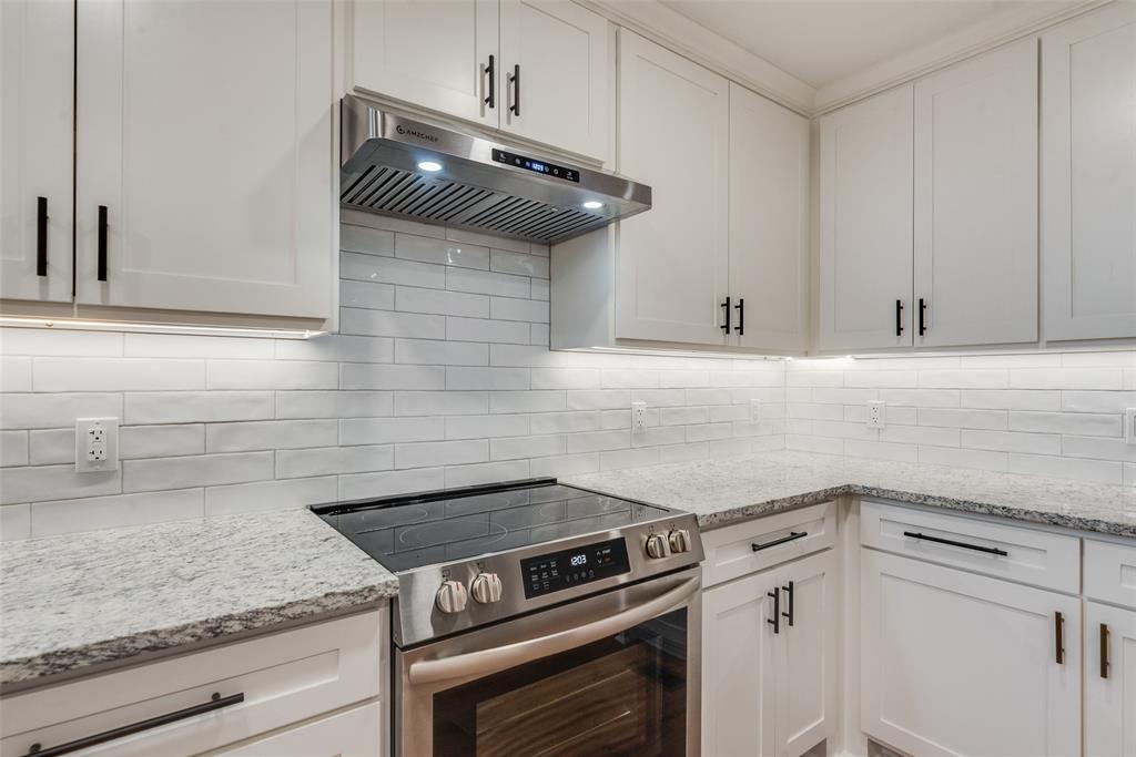 2720 Seeton Road Grand Prairie, TX 75054 - Photo 7 of 31 a kitchen with a stove and white cabinets