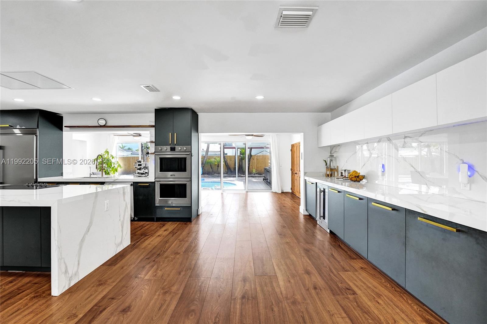 3350 North 40th Street Hollywood, FL 33021 - Photo 17 of 100 a large kitchen with lots of counter space and wooden floor