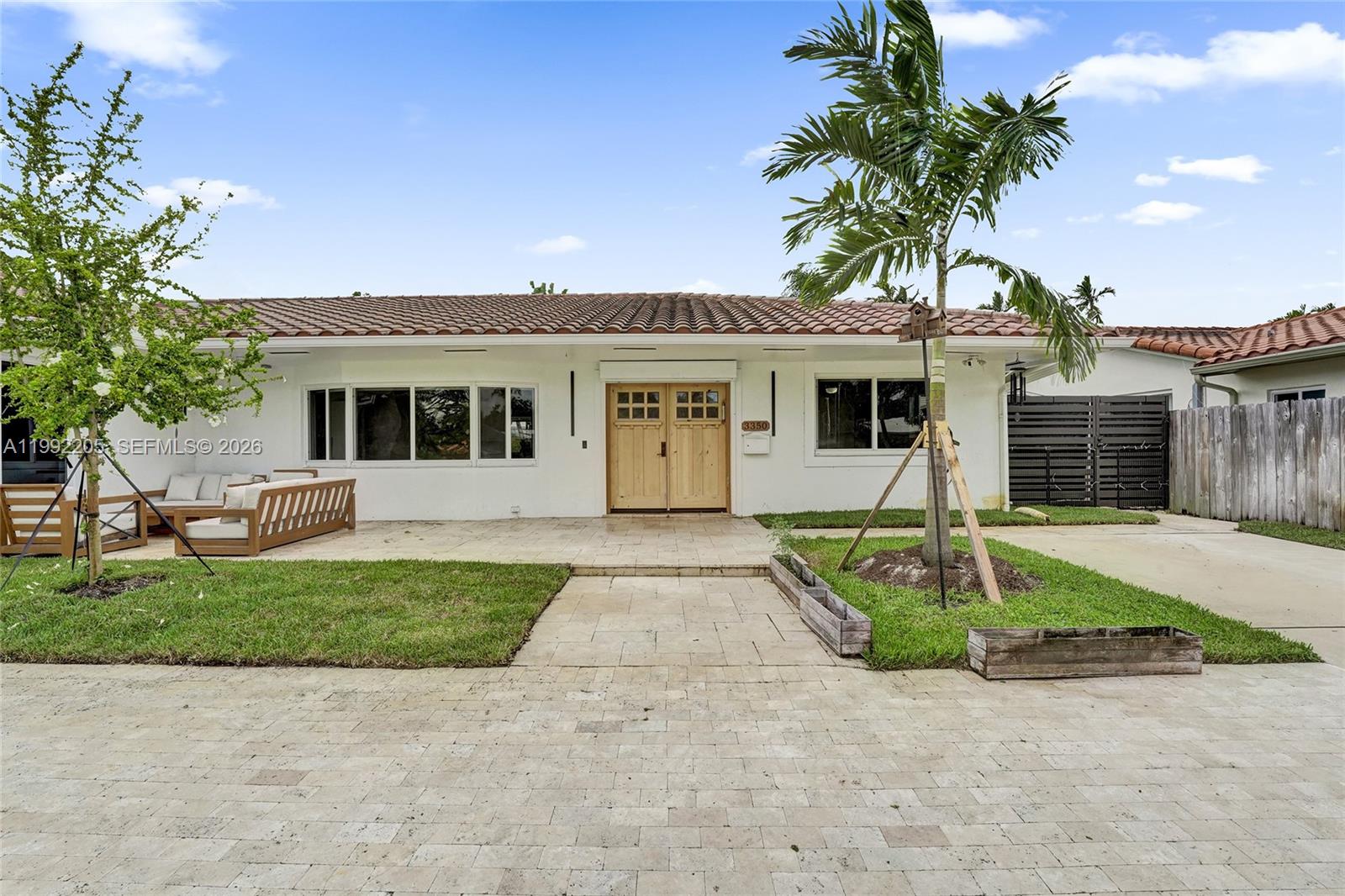 3350 North 40th Street Hollywood, FL 33021 - Photo 2 of 100 a front view of a house with a yard and garage