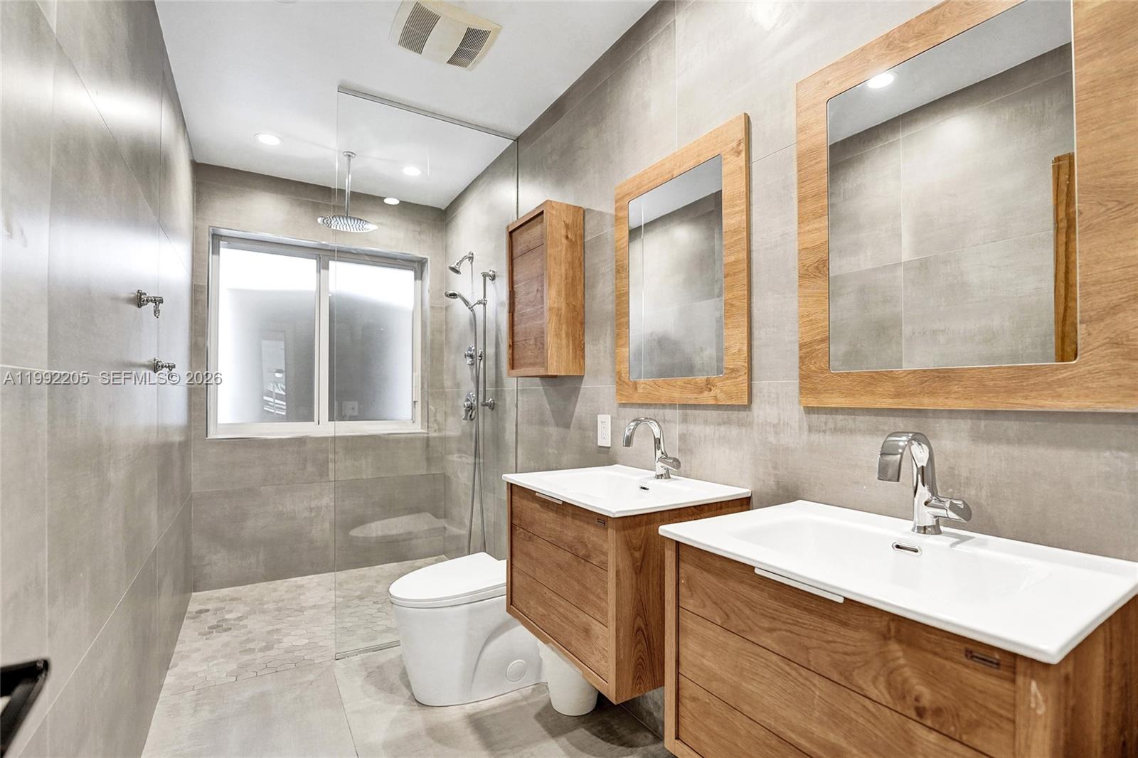 3350 North 40th Street Hollywood, FL 33021 - Photo 41 of 100 a bathroom with a double vanity sink mirror and toilet