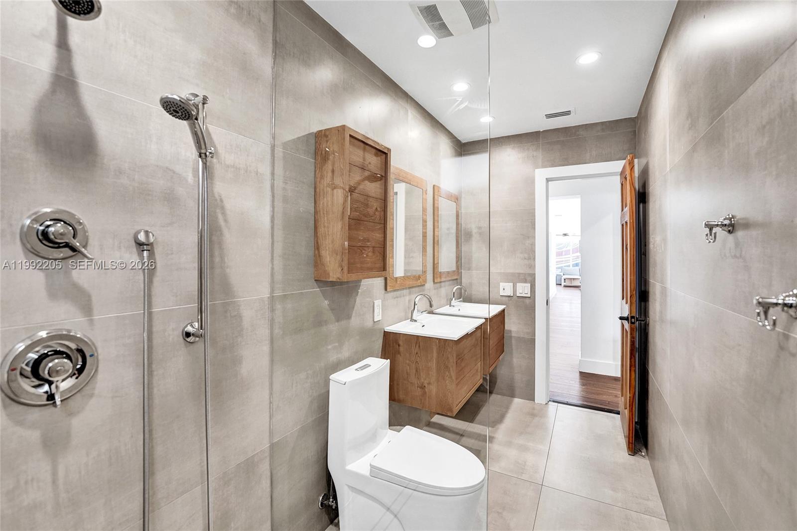 3350 North 40th Street Hollywood, FL 33021 - Photo 43 of 100 a bathroom with a toilet a sink and shower