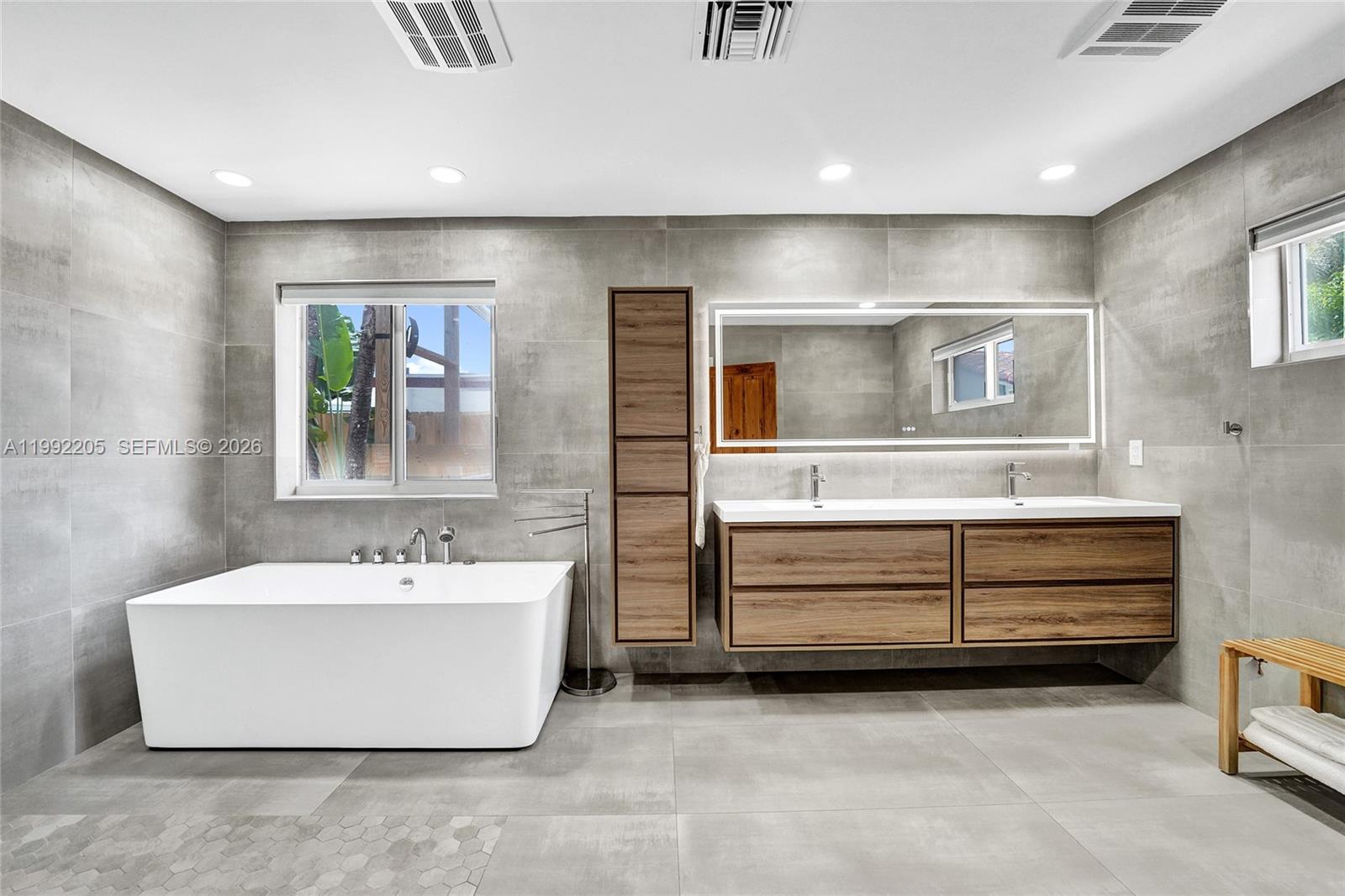 3350 North 40th Street Hollywood, FL 33021 - Photo 48 of 100 a spacious bathroom with a double vanity sink mirror and bathtub