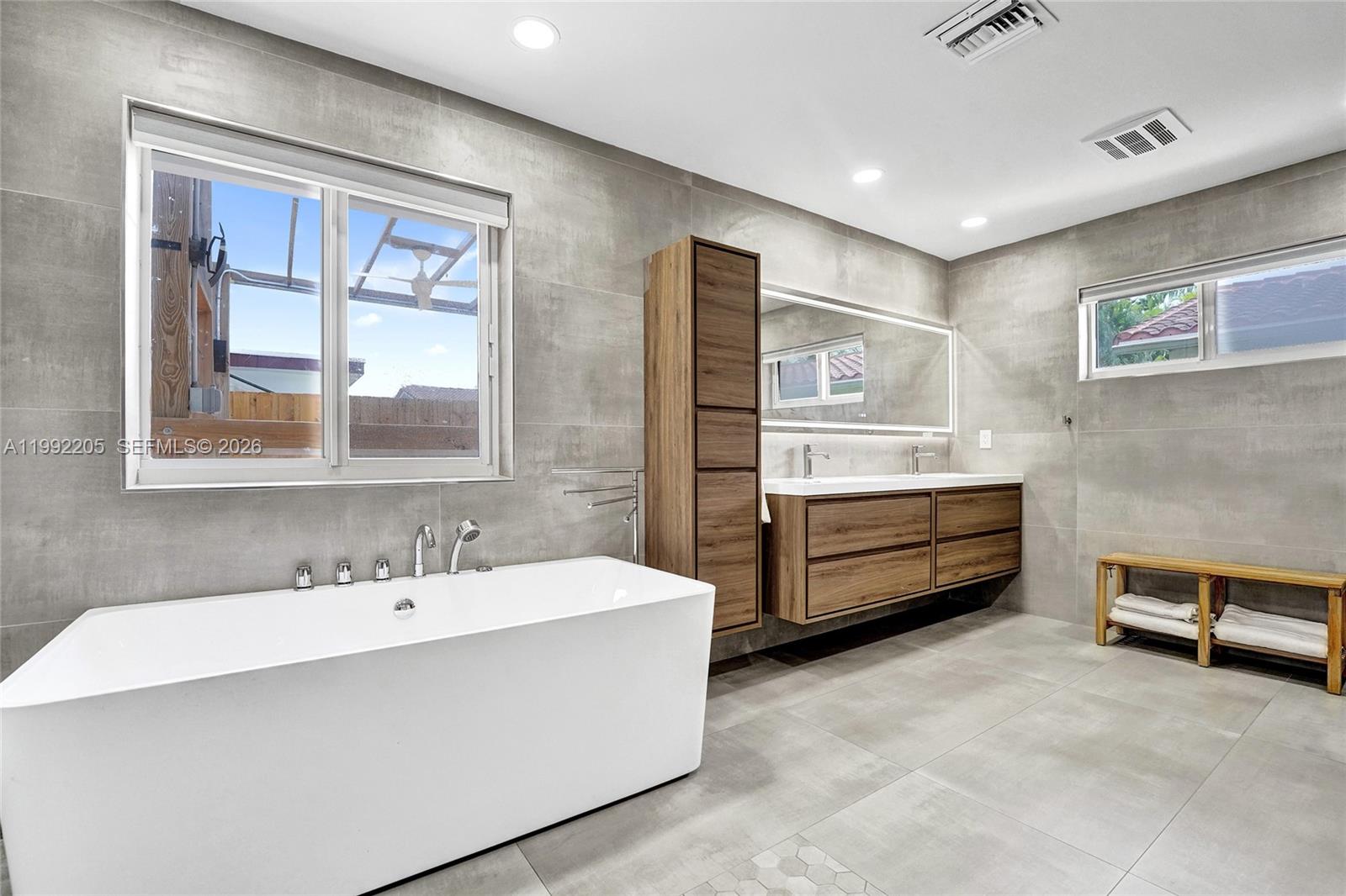 3350 North 40th Street Hollywood, FL 33021 - Photo 50 of 100 a bathroom with a double vanity sink a mirror and a bathtub