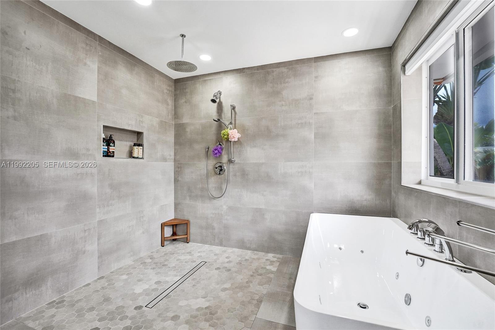 3350 North 40th Street Hollywood, FL 33021 - Photo 53 of 100 a bathroom with a tub sink a mirror and shower