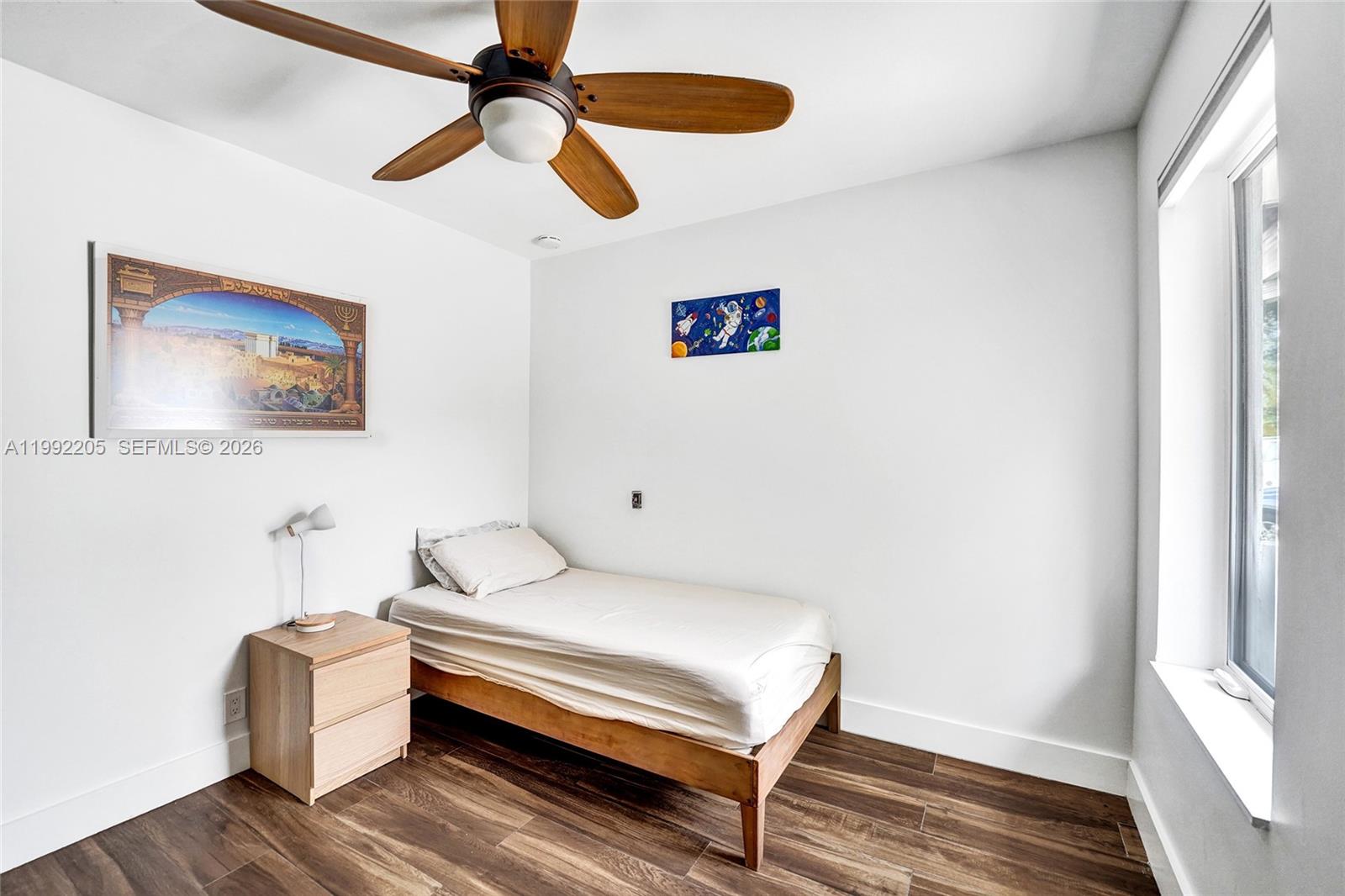 3350 North 40th Street Hollywood, FL 33021 - Photo 66 of 100 a bedroom with a bed and a chandelier