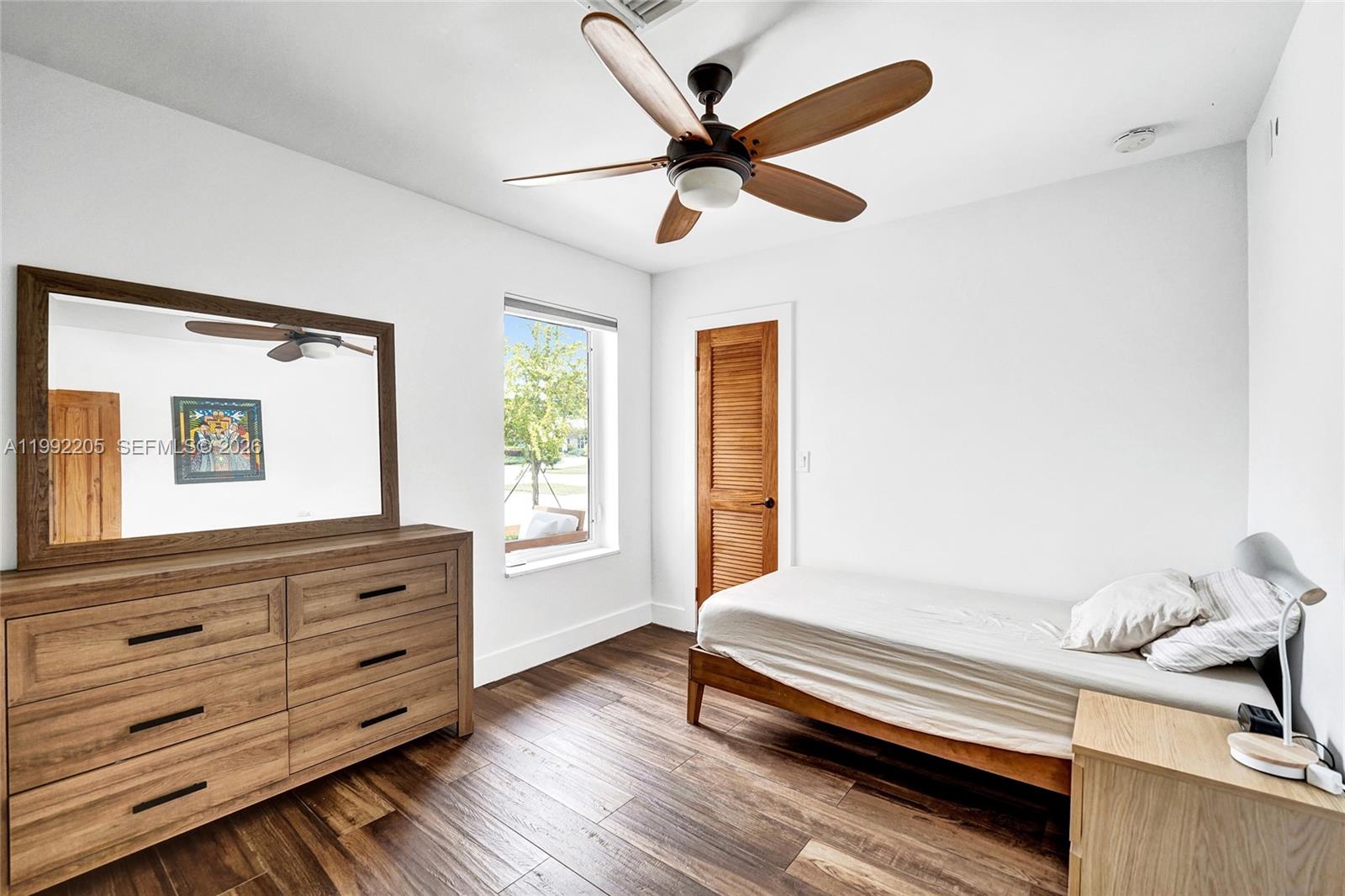 3350 North 40th Street Hollywood, FL 33021 - Photo 68 of 100 a bedroom with a bed and a chandelier