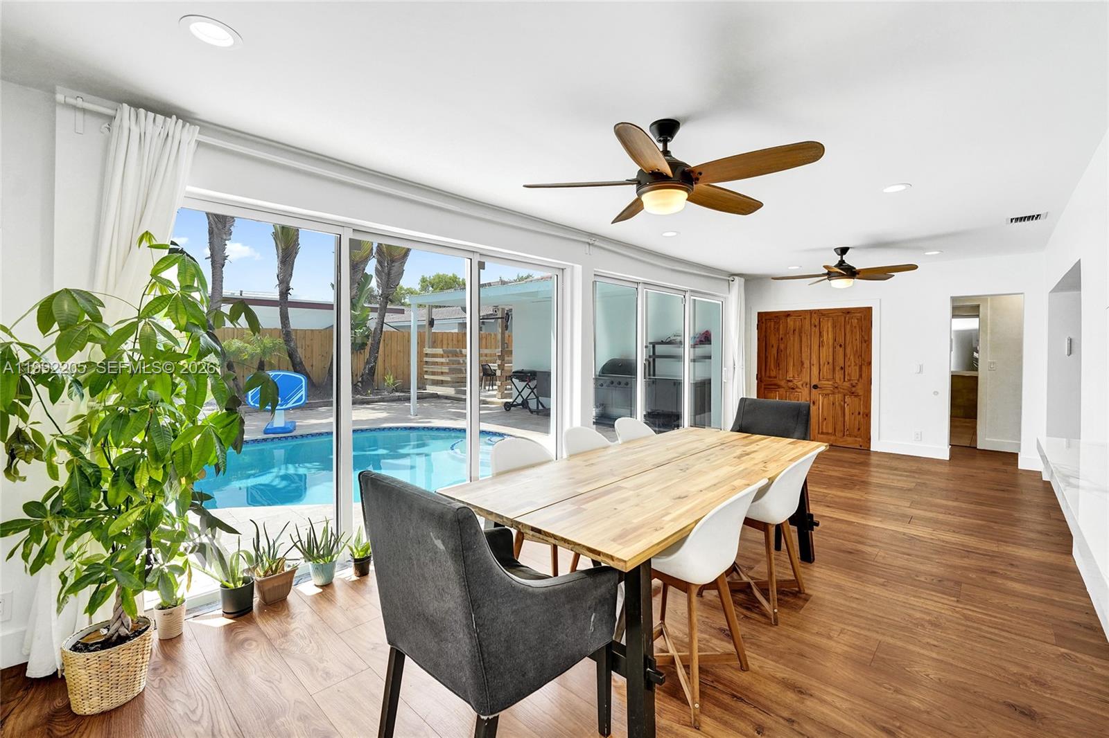 3350 North 40th Street Hollywood, FL 33021 - Photo 86 of 100 a view of a dining room with furniture window and wooden floor