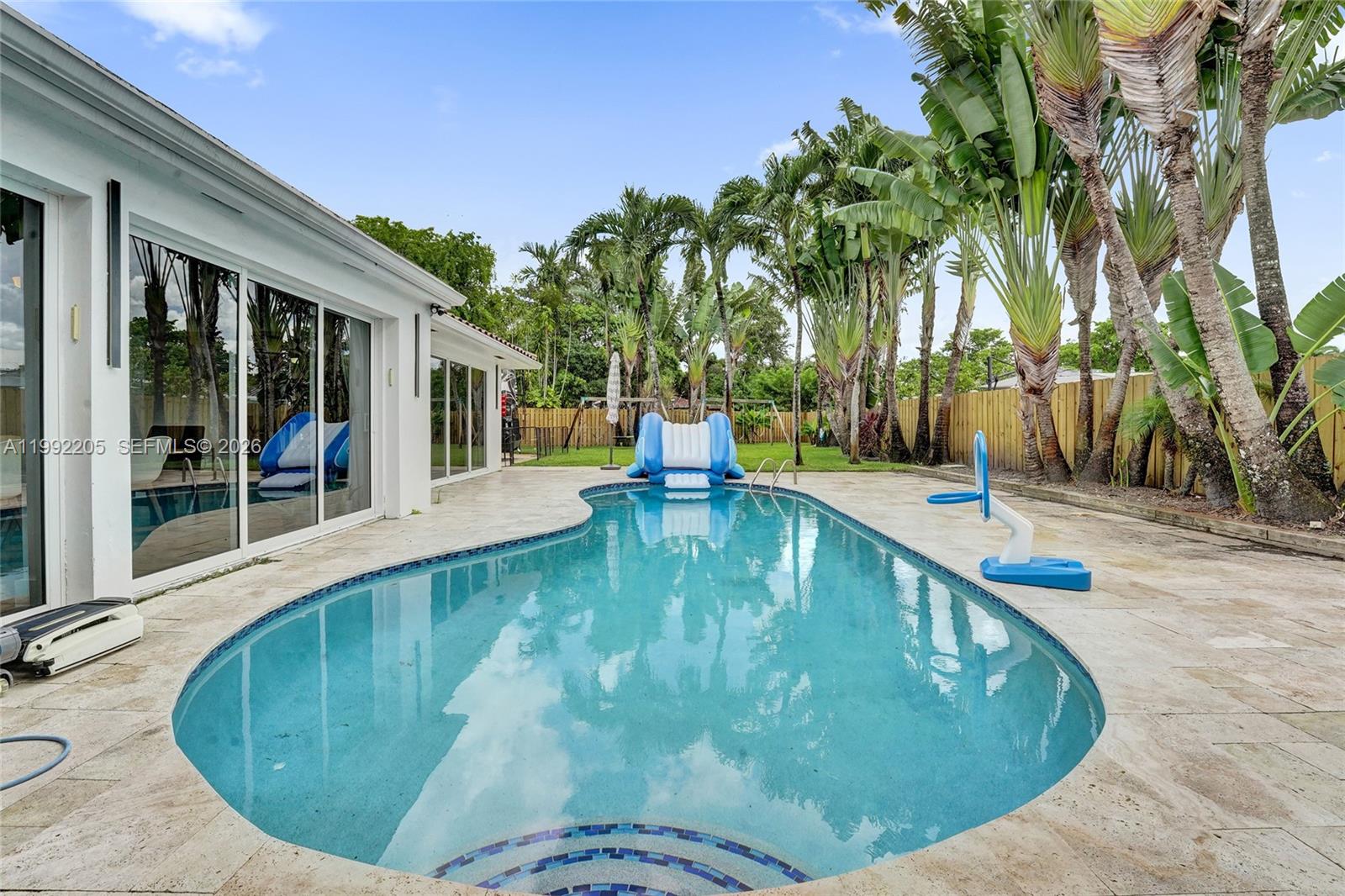 3350 North 40th Street Hollywood, FL 33021 - Photo 90 of 100 a swimming pool with outdoor seating and yard