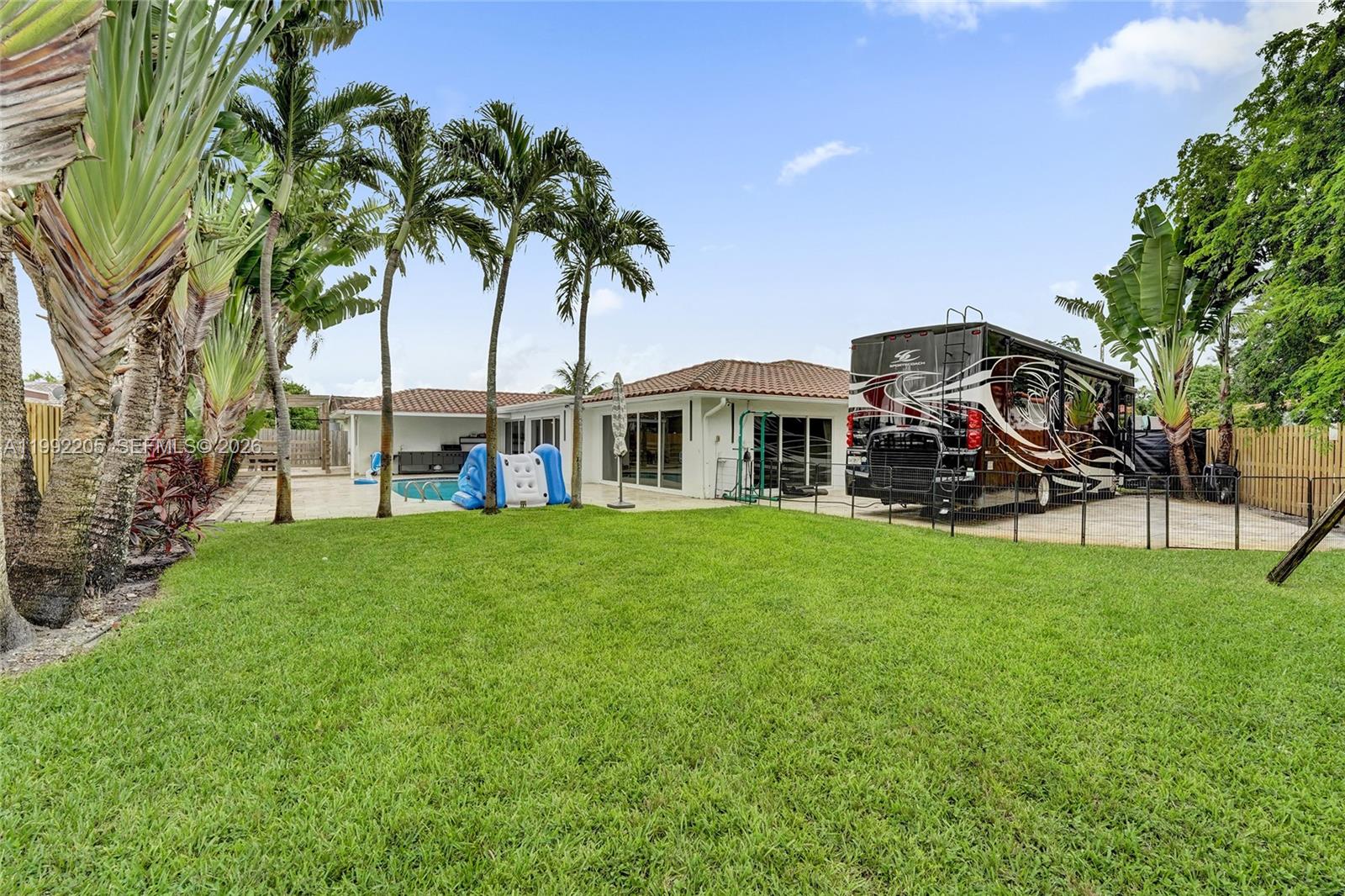 3350 North 40th Street Hollywood, FL 33021 - Photo 97 of 100 a view of a house with backyard and a tree