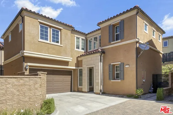 a front view of a house with a garage