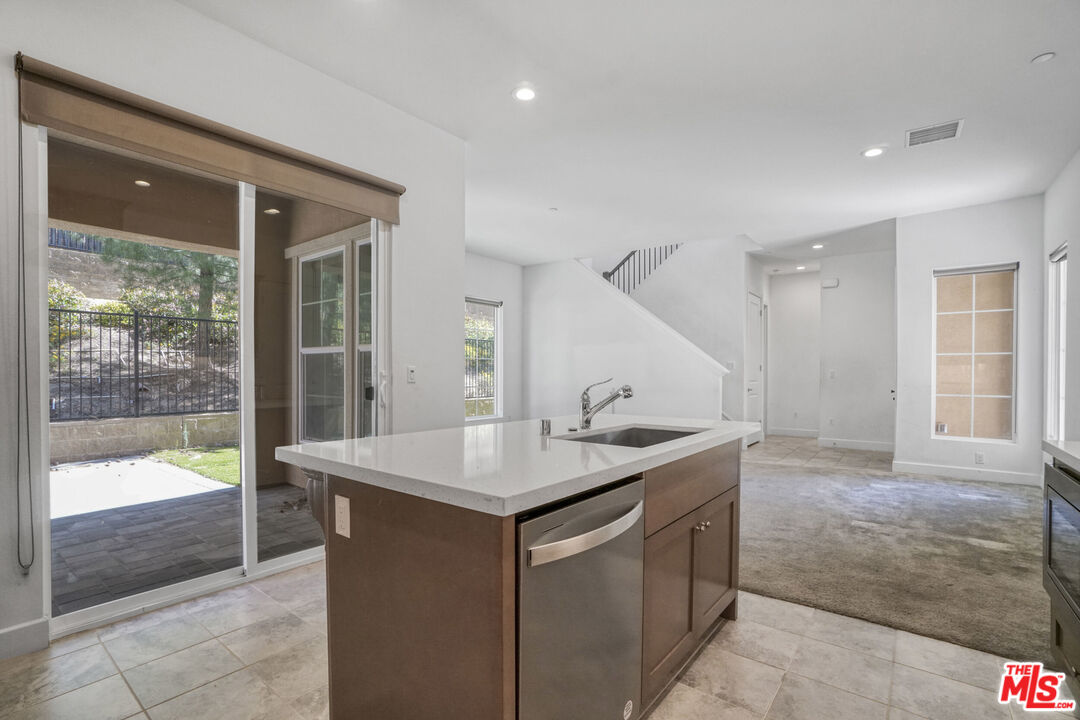 20705 West Chestnut Circle Porter Ranch, CA 91326 - Photo 11 of 35 a utility room with a sink and glass door