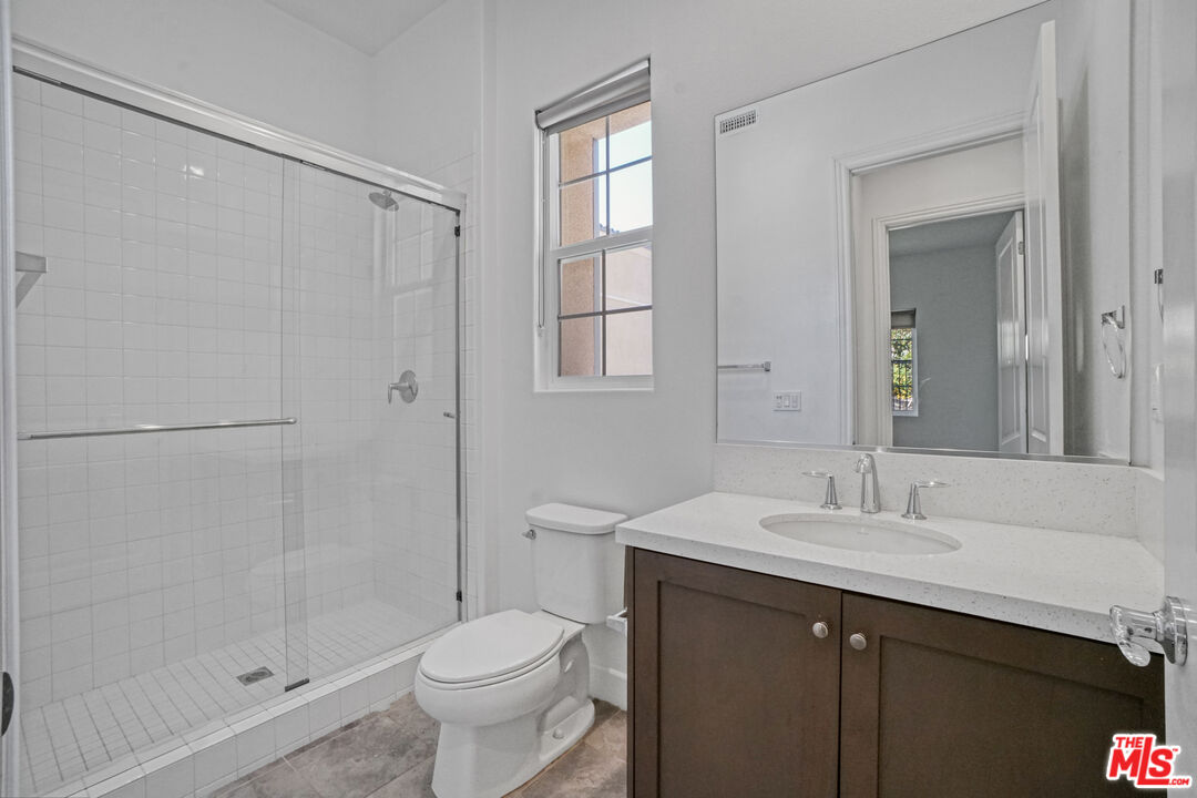 20705 West Chestnut Circle Porter Ranch, CA 91326 - Photo 12 of 35 a bathroom with a sink toilet and shower