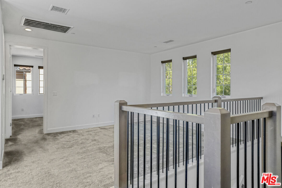20705 West Chestnut Circle Porter Ranch, CA 91326 - Photo 19 of 35 a view of a hallway with wooden floor and windows