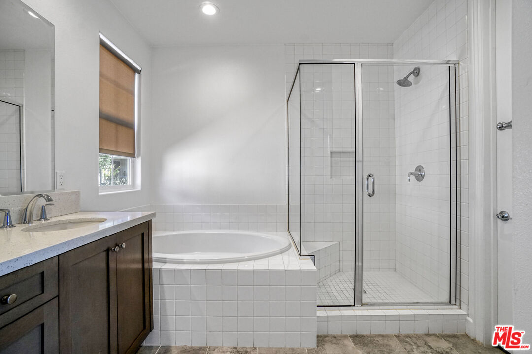 20705 West Chestnut Circle Porter Ranch, CA 91326 - Photo 23 of 35 a bathroom with a granite countertop sink mirror and shower