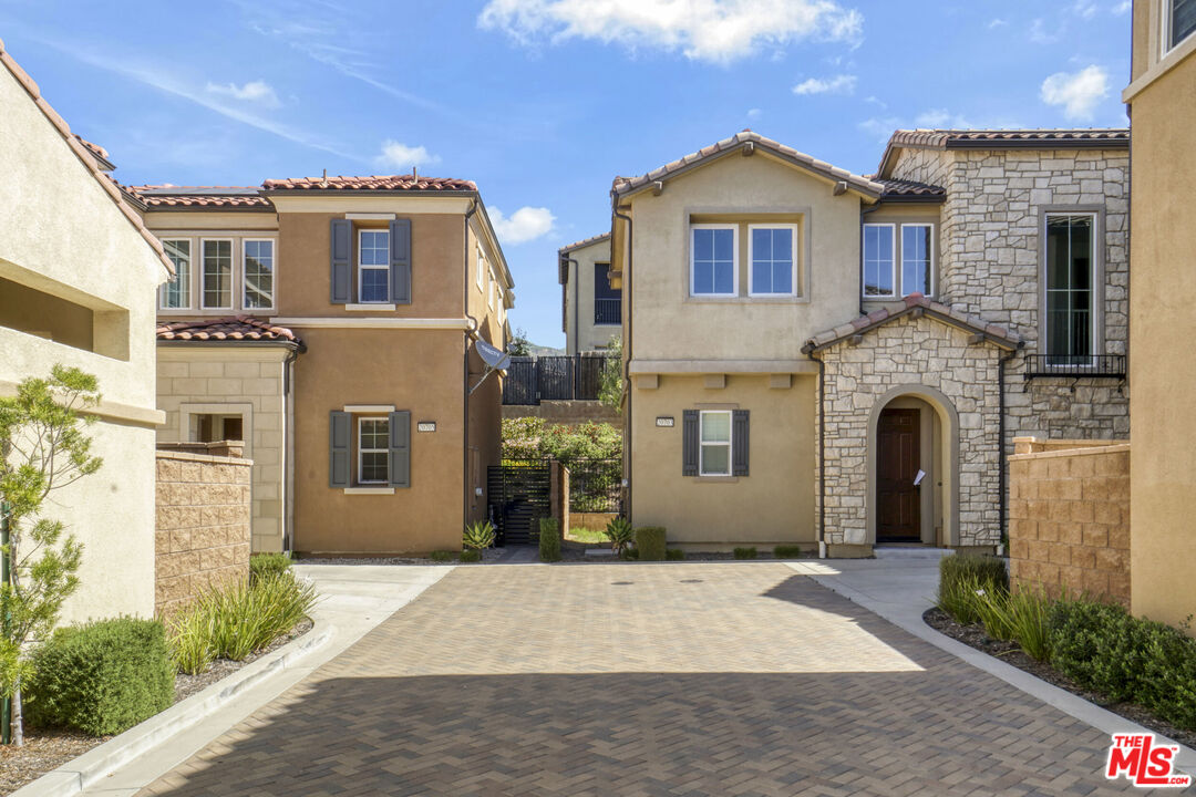 20705 West Chestnut Circle Porter Ranch, CA 91326 - Photo 33 of 35 a front view of a house with a garden