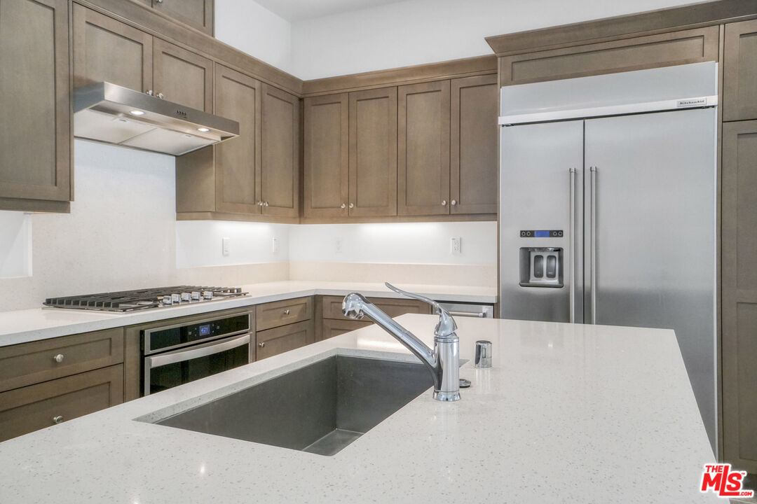 20705 West Chestnut Circle Porter Ranch, CA 91326 - Photo 10 of 35 a kitchen with a stove and a refrigerator