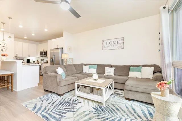 a living room with furniture and kitchen view