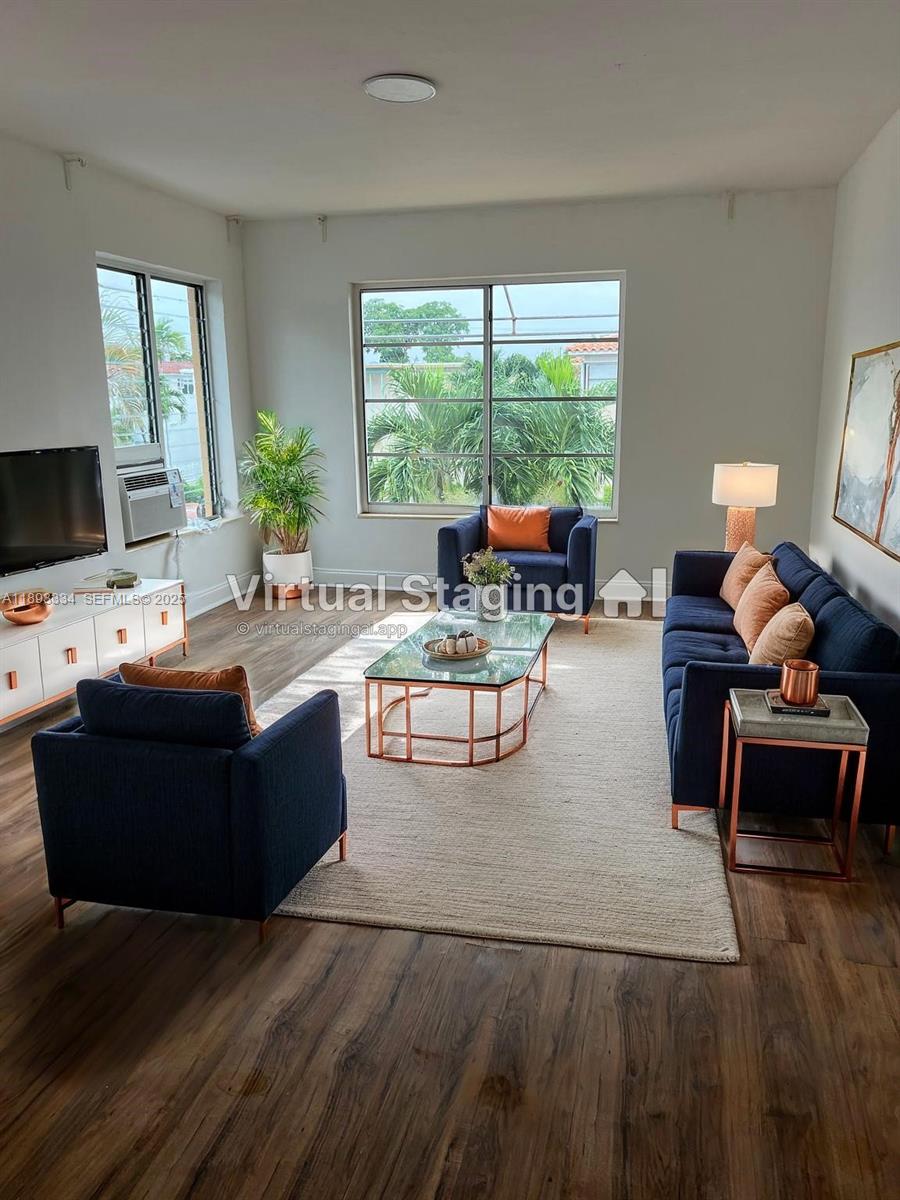 7333 Byron Avenue, Unit 7335 Miami Beach, FL 33141 - Photo 1 of 5 a living room with furniture and a large window