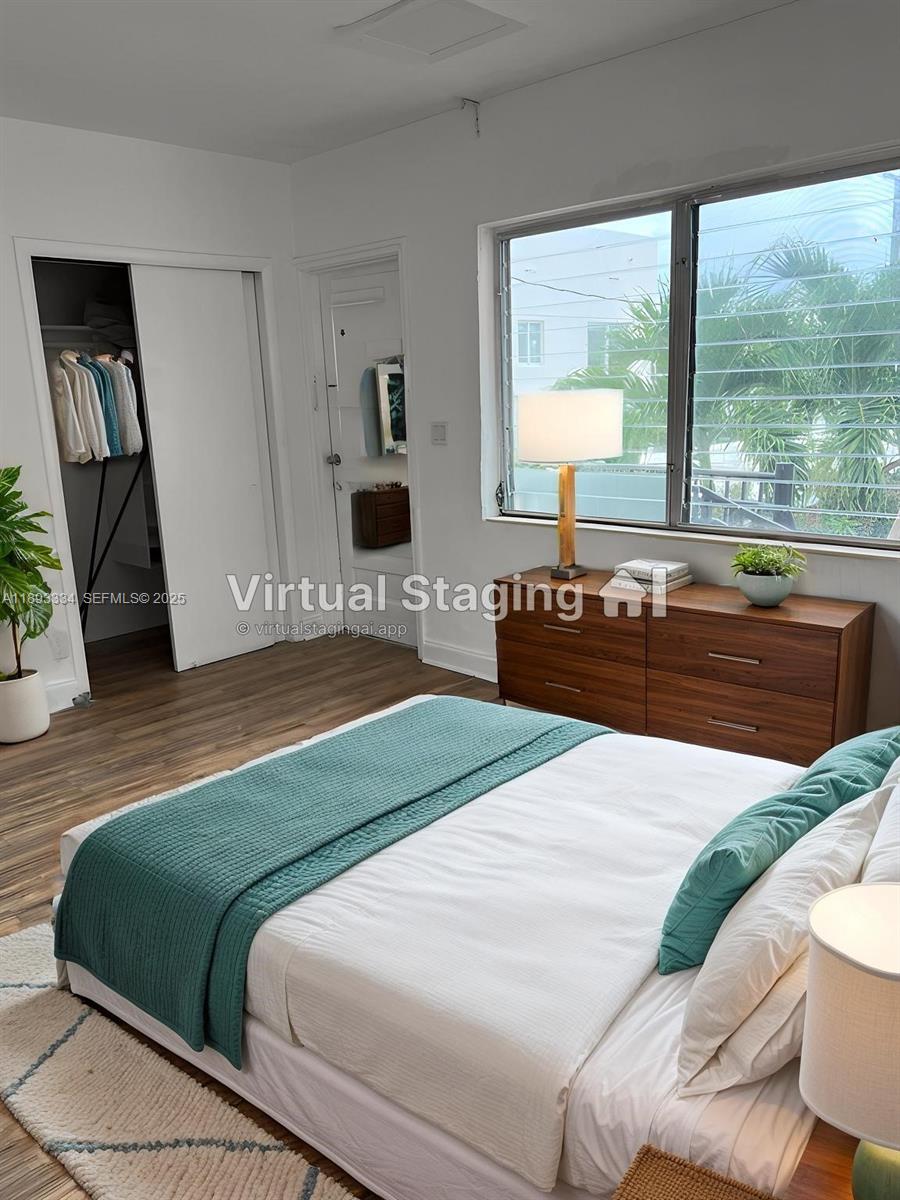 7333 Byron Avenue, Unit 7335 Miami Beach, FL 33141 - Photo 2 of 5 a bedroom with a bed and wooden floor