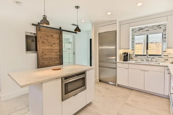 a kitchen with stainless steel appliances granite countertop a stove and a refrigerator