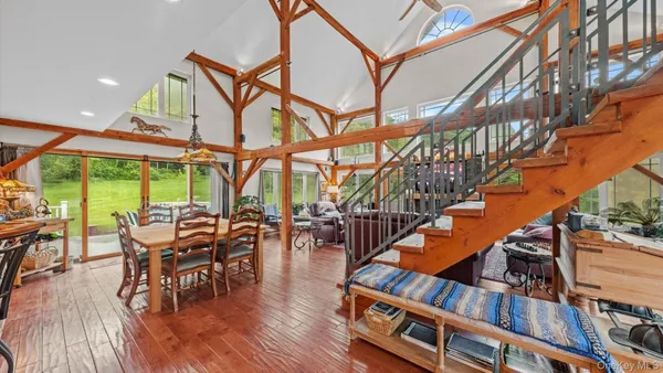 a dining room with furniture entryway and wooden floor