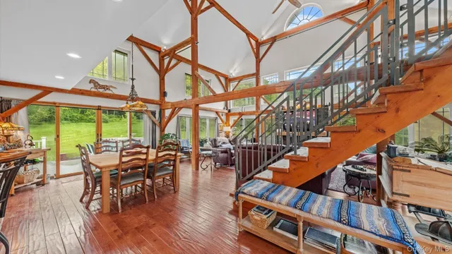 a dining room with furniture entryway and wooden floor
