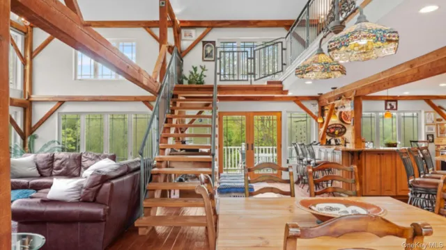 a living room with furniture a large window and chairs