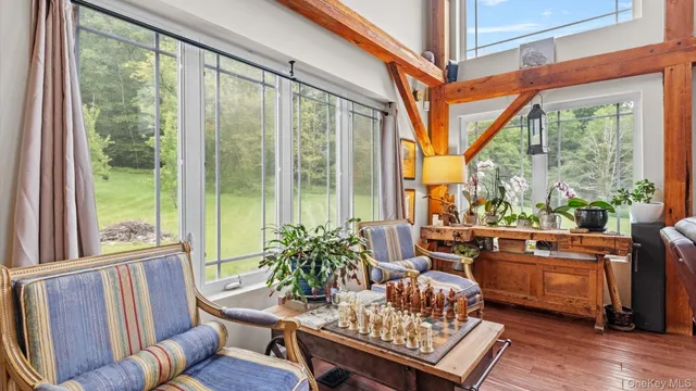 a living room with furniture and a floor to ceiling window