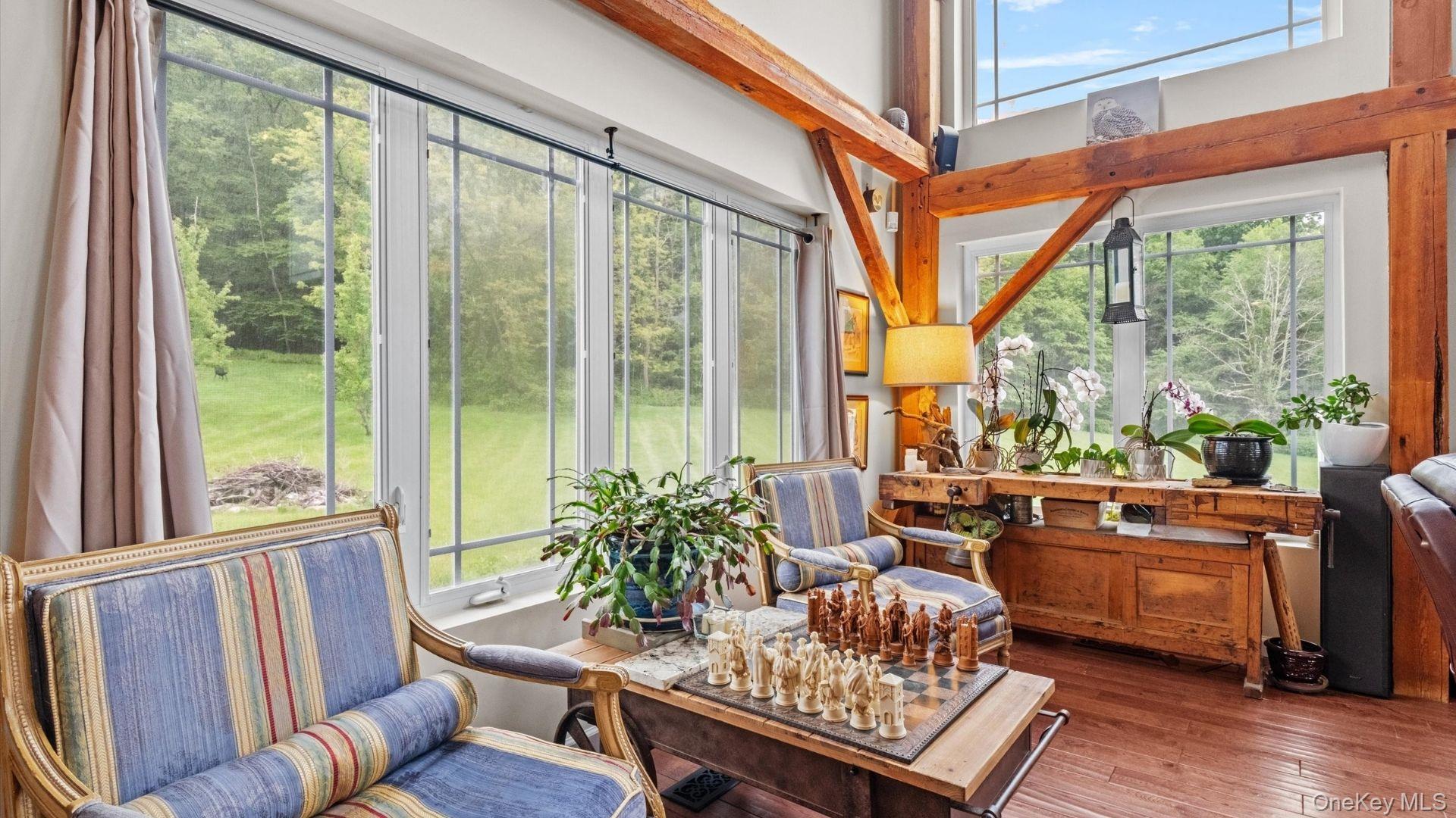 42 Blackstone Ridge Holmes, NY 12531 - Photo 19 of 43 a living room with furniture and a floor to ceiling window