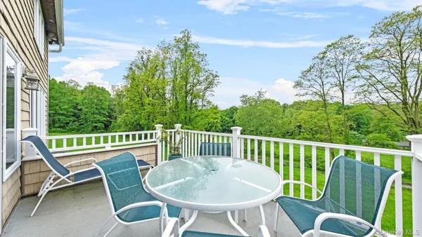 a view of a chair and table in the balcony