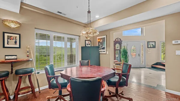 a view of a dining room with furniture window and wooden floor