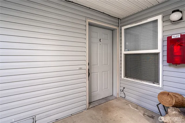 a view of a swimming pool with lawn chairs and plants