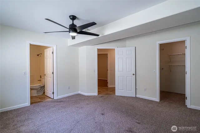 a view of empty room with ceiling fan
